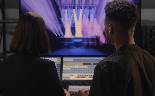 Two people cueing a show